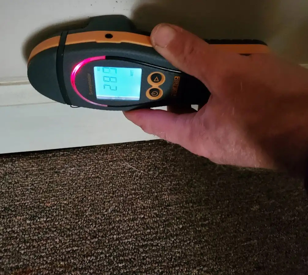Moisture detection at baseboard during Storm Damage Restoration in De Soto